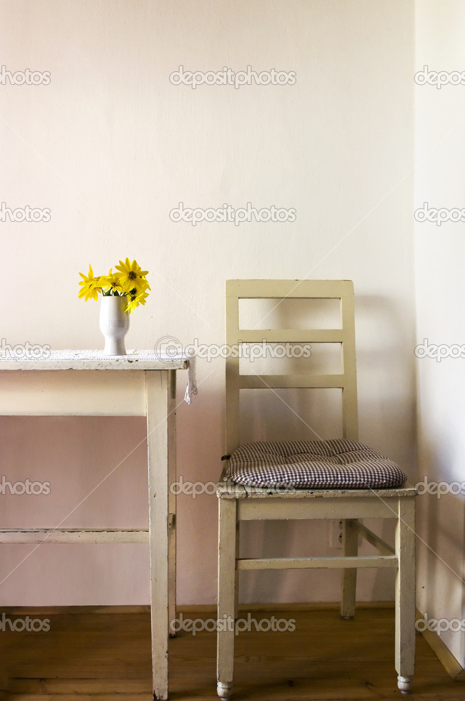 Table, chair and flowers