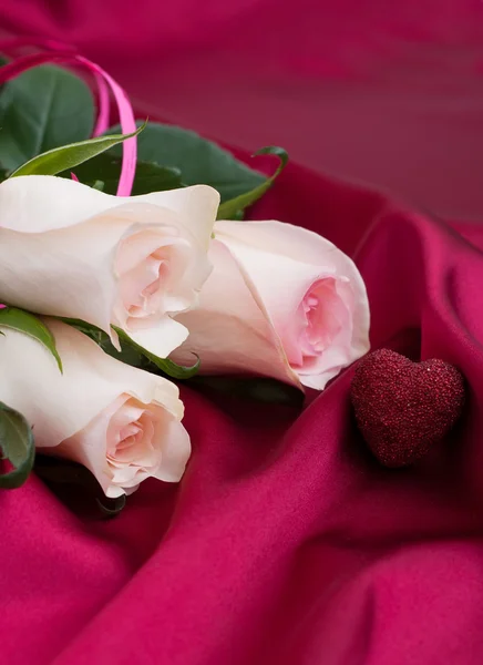 Roses on satin background — Stock Photo, Image