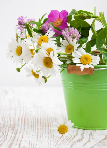 Bucket with wild flowers — Stock Photo, Image