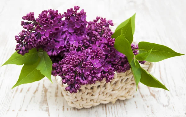 Summer lilac flowers in basket — Stock Photo, Image