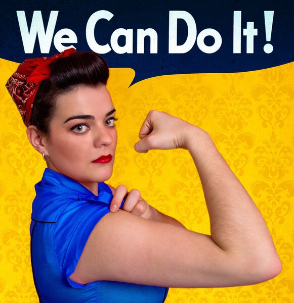 Young woman posing as working girl like the original poster of Rosie the Riveter, year 1943
