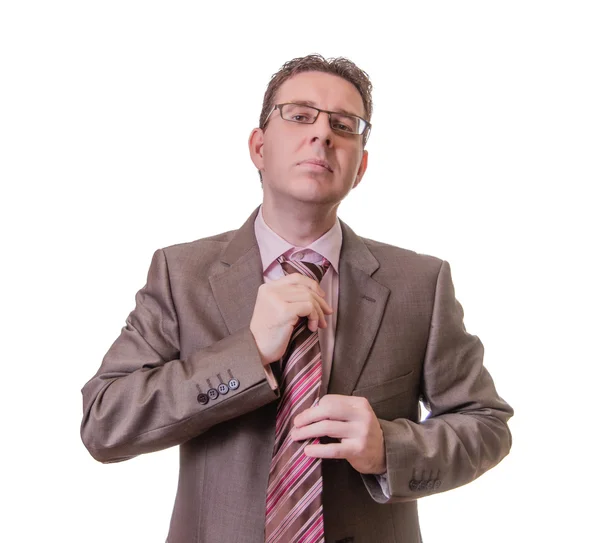 Thoughtful businessman putting his tie on white background — Stock Photo, Image