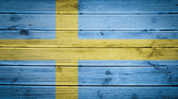 Ahşap doku arka plan ile İsveç bayrağının renkleri — Stok fotoğraf