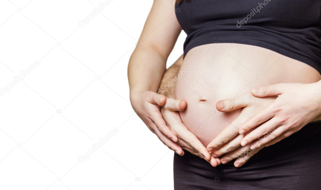 Pregnant woman touching her belly with hands and her husband too