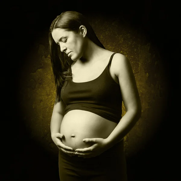 Beautiful pregnant looking her belly — Stock Photo, Image