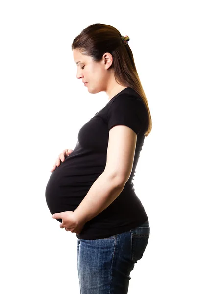 Beautiful expectant pregnant looking her belly isolated Stock Photo