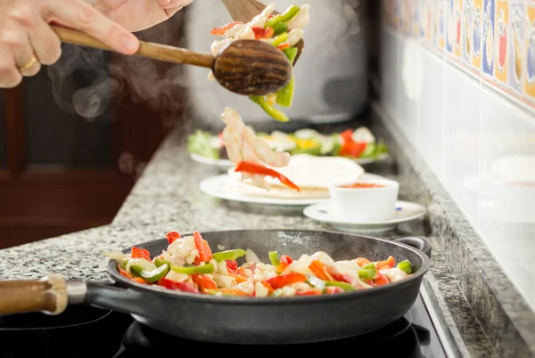 Крупный план человека, готовящего овощи и курицу на сковороде — стоковое фото