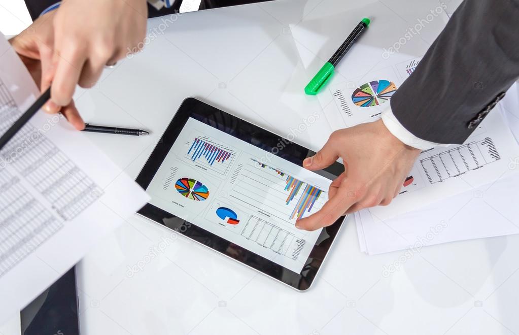 Business people analyzing documents in a meeting