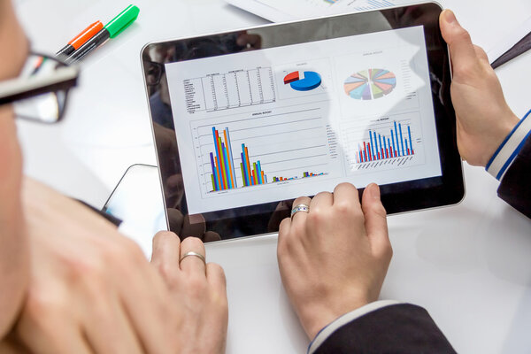 Business people analyzing documents in a meeting