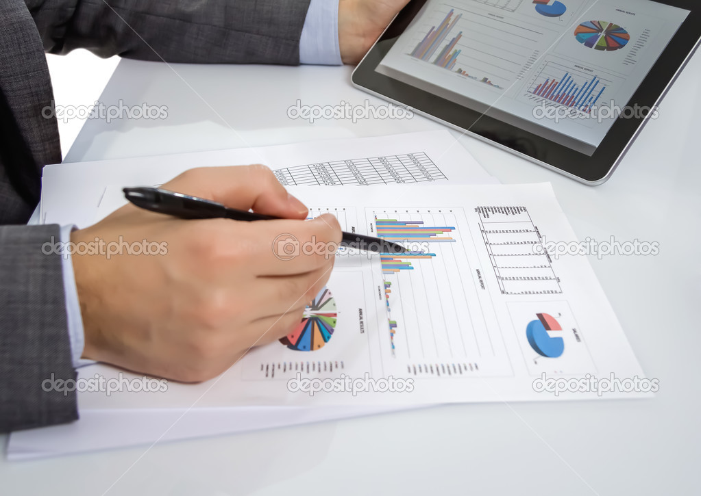 Businessman reviewing documents in digital tablet