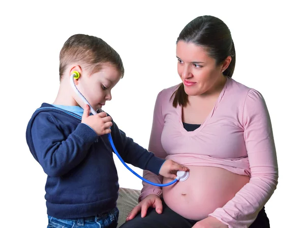 Child doctor examining his pregnant mother — Stock Photo, Image
