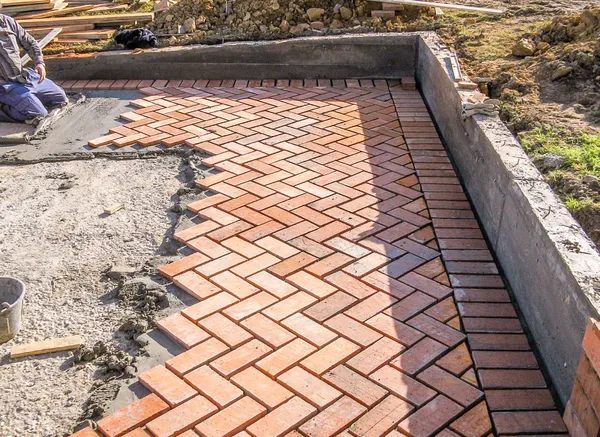 Orange brick paving stones in construction process — Stock Photo, Image