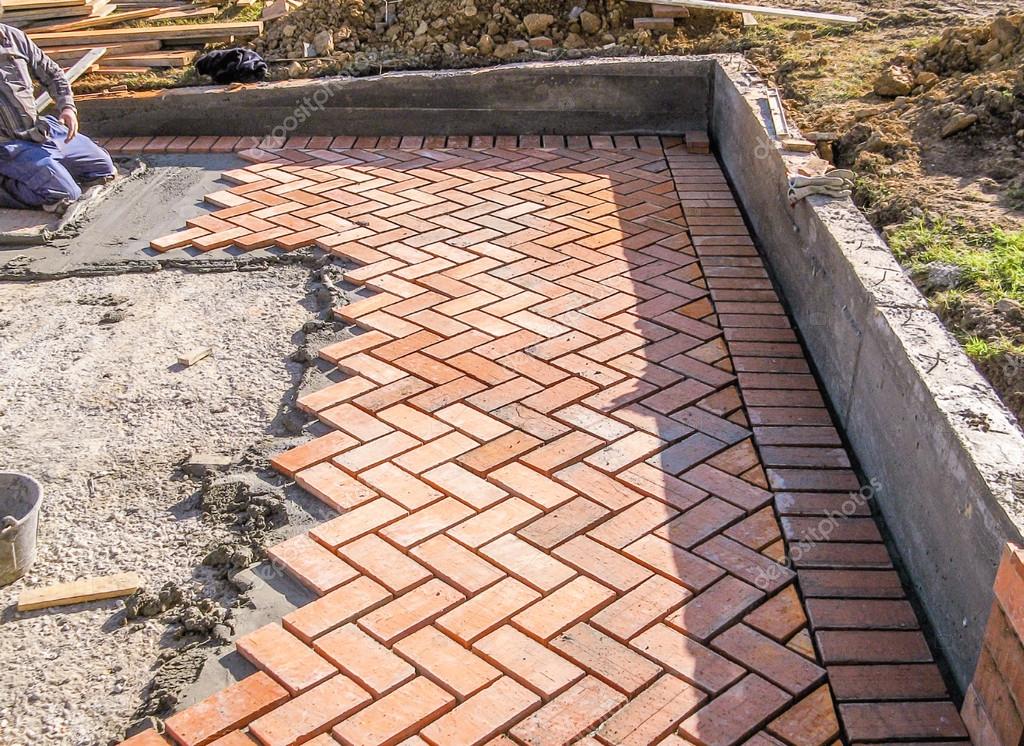 Orange brick paving stones in construction process ⬇ Stock Photo, Image
