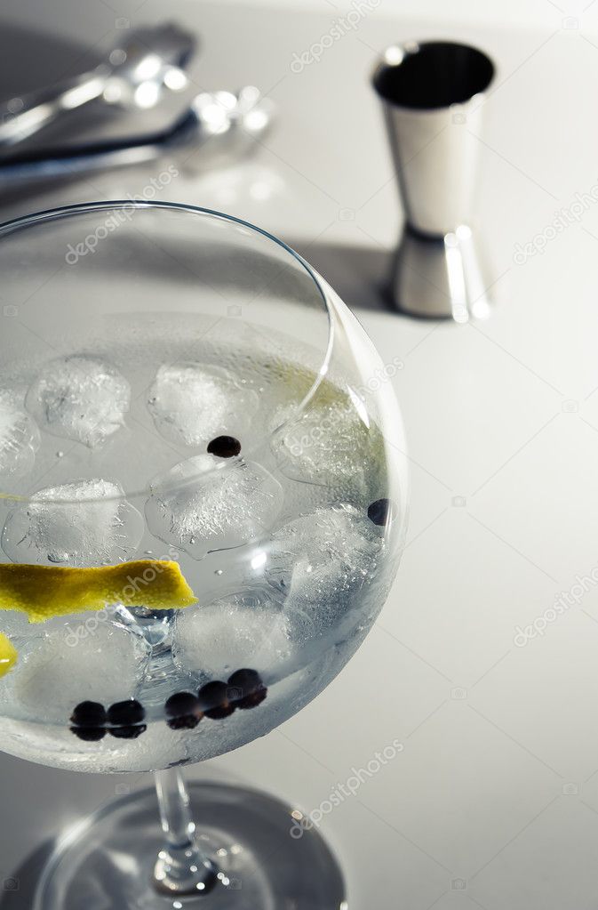 Gin tonic cocktail over a club bar background