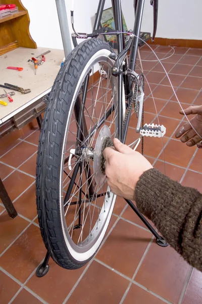 Real bicycle mechanic repairing custom fixie bike — Stock Photo, Image