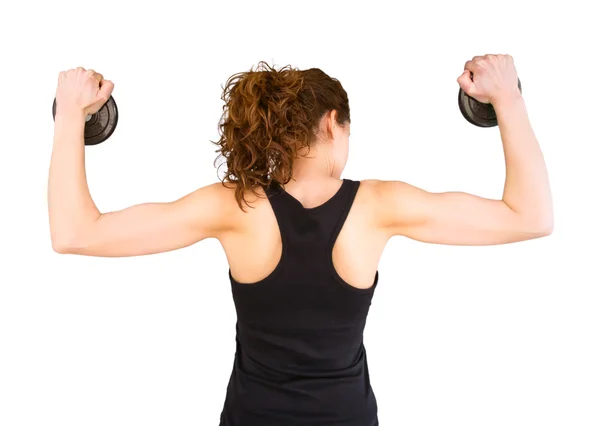 Back view of young girl lifting dumbbell discs — Stock Photo, Image