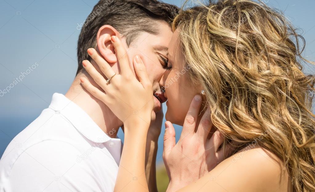 Passionate love couple kissing on a summer day