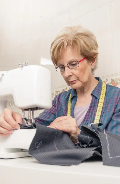 Senion couturière femme travaillant sur la machine à coudre — Photo