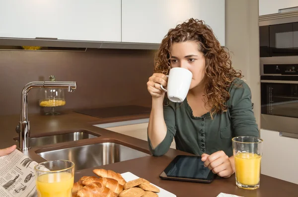 Tired young girl with cup of coffee in a breakfast — Stock Photo, Image