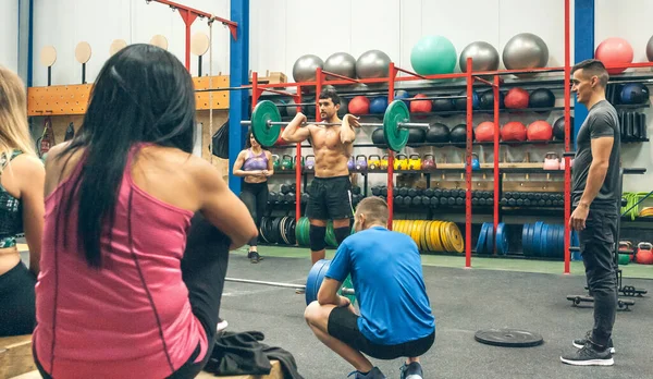Treinador explicando levantamento de peso no ginásio — Fotografia de Stock