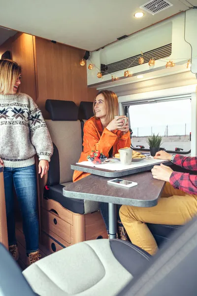 Amigos tomando café da manhã em uma van campista pela manhã — Fotografia de Stock