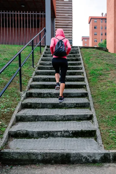 Atleta mujer subiendo escaleras al aire libre — Foto de Stock
