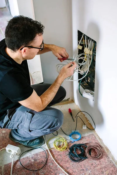Technicien câble de coupe pour installer la boîte de télécommunication — Photo