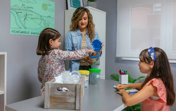 Girl Recycling Paper Her Female Teacher Ecology Classroom — Stock Photo, Image