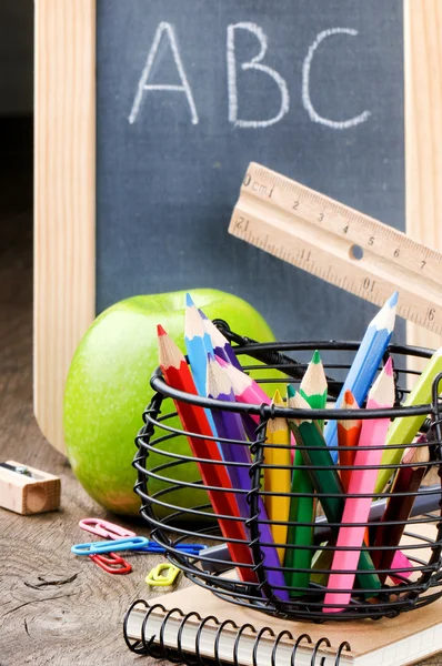 Chalkboard and colorful crayons — Stock Photo, Image