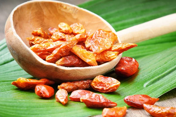 Red hot chili peppers on a wooden spoon — Stock Photo, Image