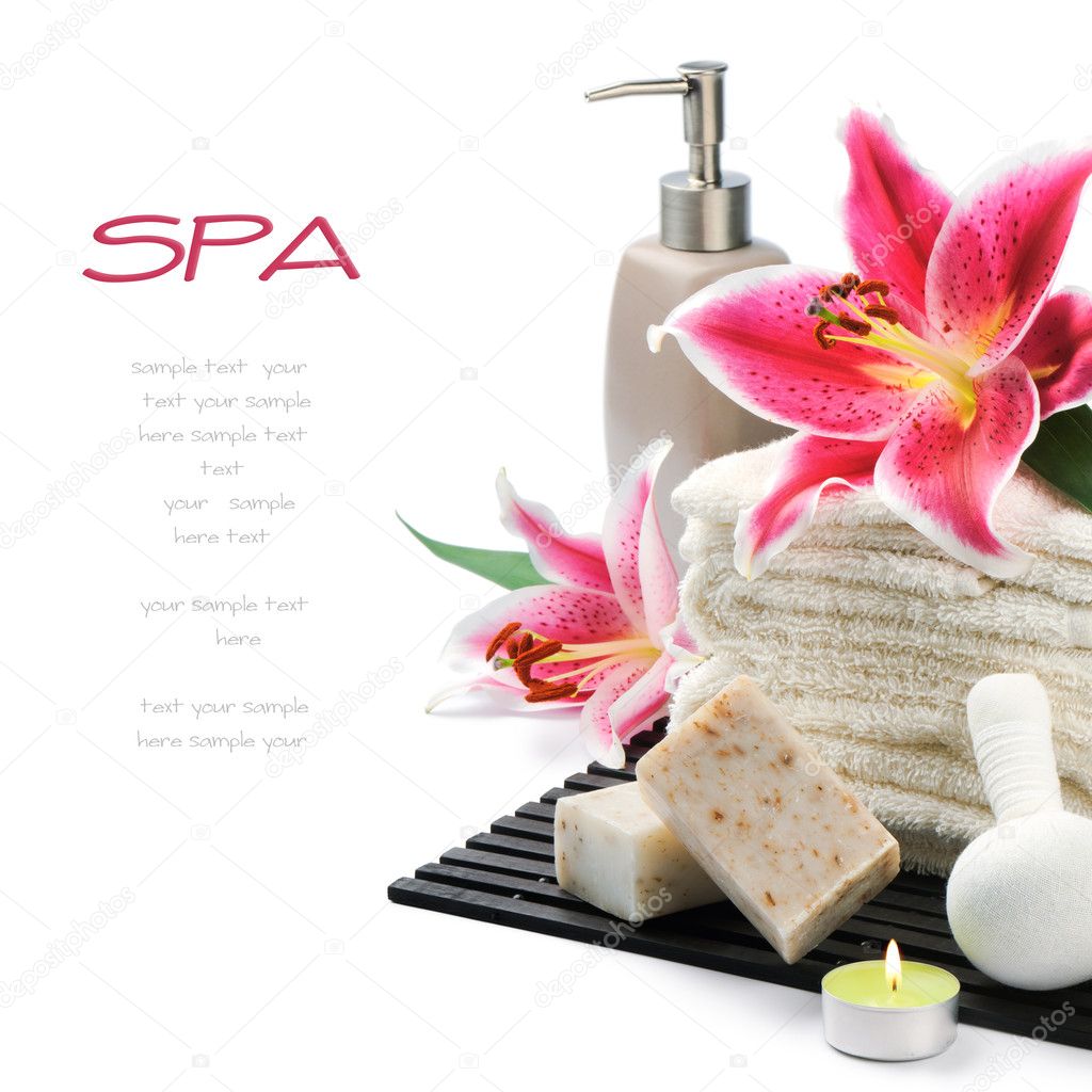 Spa setting with towels, organic soap and lily