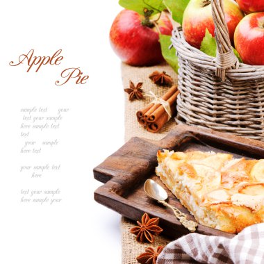 Piece of homemade apple pie with fresh apples in basket