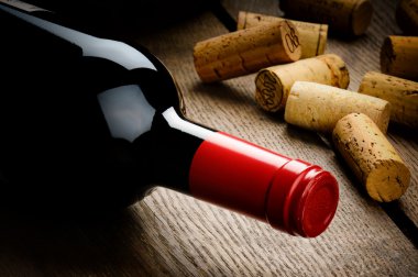 Bottle of red wine and corks clipart