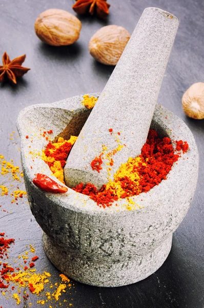 Mortar with chili pepper and curry powder — Stock Photo, Image