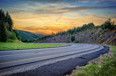Landscape with curvy road at sunset clipart