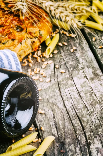 Rustic setting with bottle of red wine — Stock Photo, Image