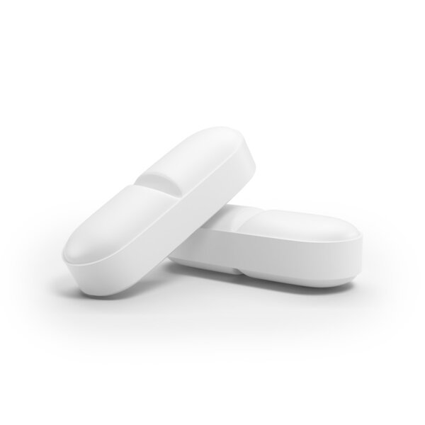 Две белые таблетки изолированы
