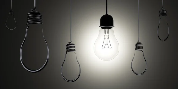 Hanging light bulbs silhouettes with glowing one — Stock Photo, Image