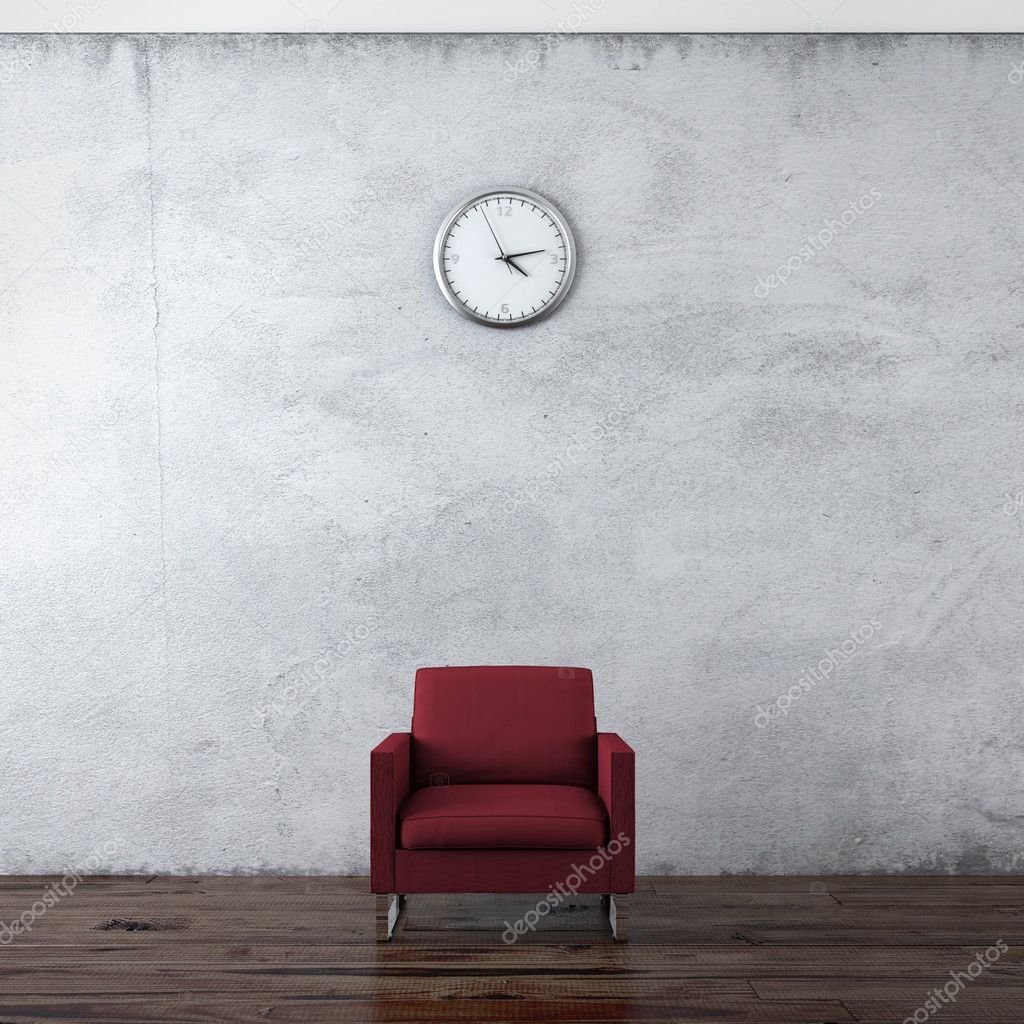 A wall clock and red chair