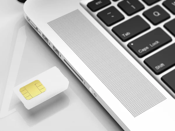 Cartão SIM e laptop — Fotografia de Stock