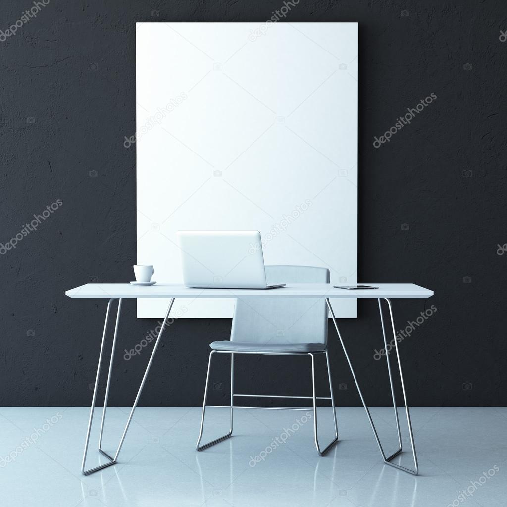 laptop on table in interior with black wall