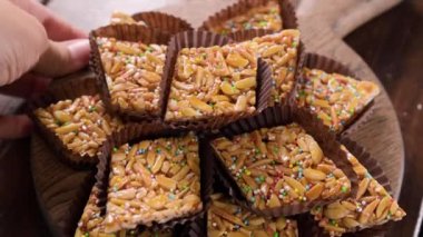 Desserts with almonds, peanuts and seeds in caramel. Traditional Sardinian sweet. Sweet squares. High quality 4k footage. Almond Gateau, sarda Food, Italian Dessert