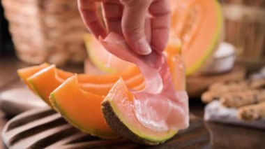 Kavunlu İtalyan jambonu. Kavunlara sarılmış geleneksel jambon dilimleri. Lezzetli aperatif. Yemek arkaplanı. Kapatın. Şarap için aperatif.