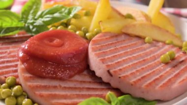 TENERONI WITH COOKED HAM.Soft Italian cutlets with prosciutto cotto, usually prepared for childrens meals and snacks. served with potatoes and vegetables with tomato paste or ketchup.4k footage