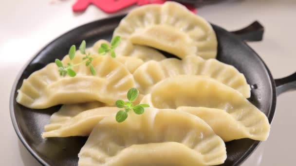 ディム 自家製中華餃子はブラックプレートで提供されています 箸で食べる 東洋料理 伝統的なランチの軽食 高品質4K映像 — ストック動画