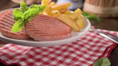 TENERONI WITH COOKED HAM.Soft Italian cutlets with prosciutto cotto, usually prepared for childrens meals and snacks. served with potatoes and vegetables served with basil leaves.4k footage