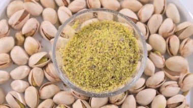 Pistachios. Nuts pistachios with shells and ground in a cup. Close-up. Food with vitamins and minerals for a healthy diet. High quality FullHD footage