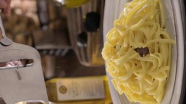  Black truffle on tagliatelle pasta. Expensive lunch, homemade pasta, traditional in the Lazo region of Italy. footage