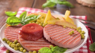 TENERONI WITH COOKED HAM.Soft Italian cutlets with prosciutto cotto, usually prepared for childrens meals and snacks. served with potatoes and vegetables with tomato paste or ketchup.4k footage
