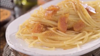 Spaghetti with bottarga. Typical Sardinian Cuisine. A dish with traditional Italian pasta from the South, dried sardine roe, lemon and pasta. High quality 4k footage